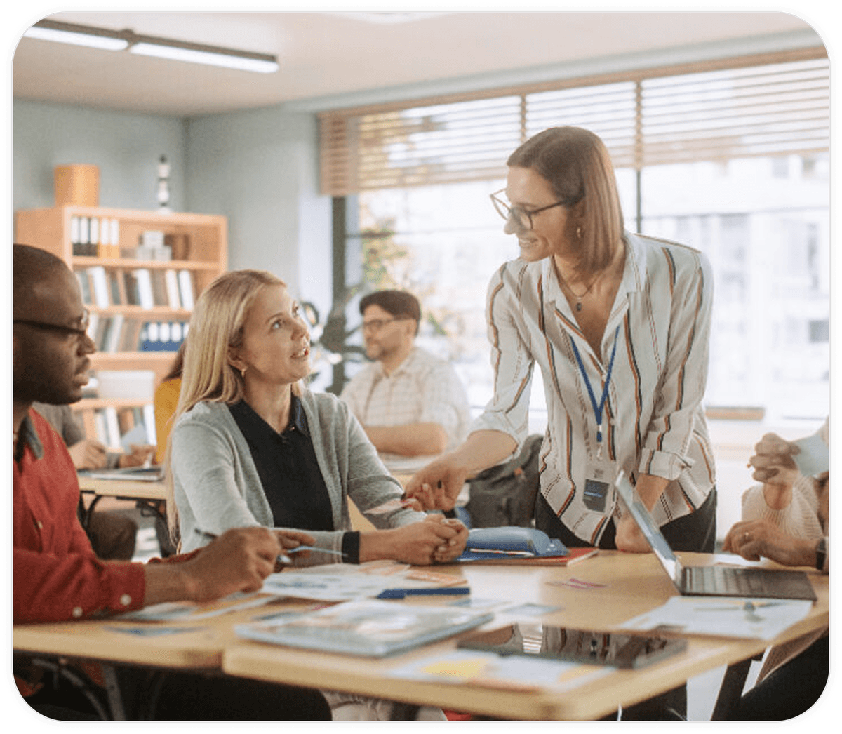 Teacher woman teaches two students in a classroom
